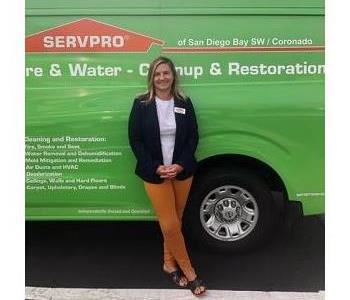 Female employee in front of van 